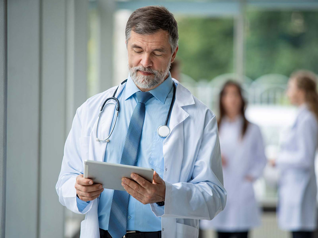 Healthcare professional using a tablet.