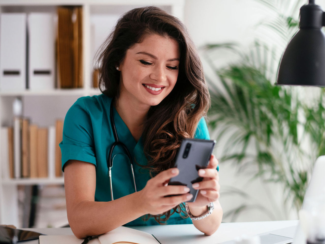Healthcare professional using a cellphone.