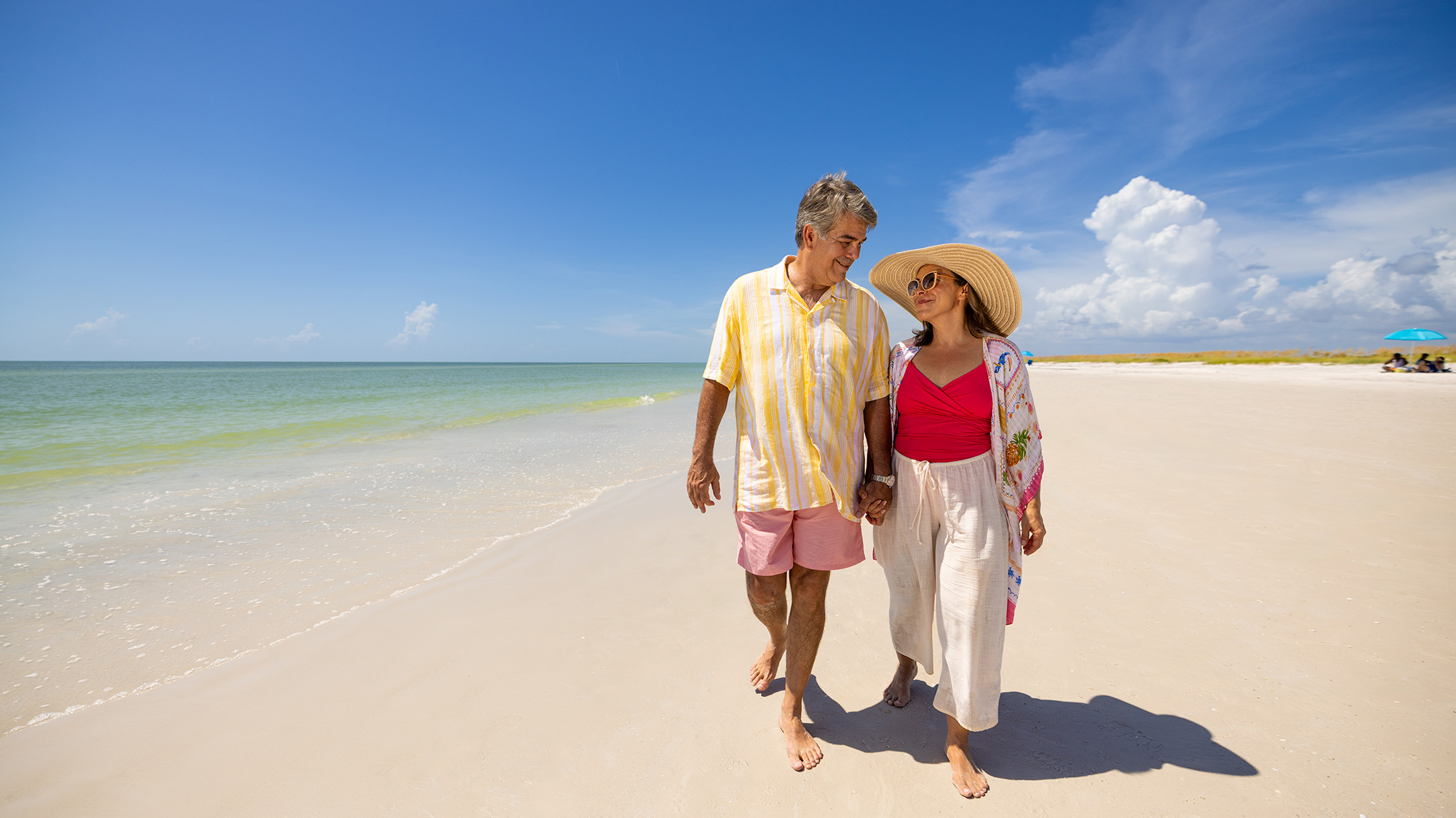 Senior couple enjoying a walk on the beach.
