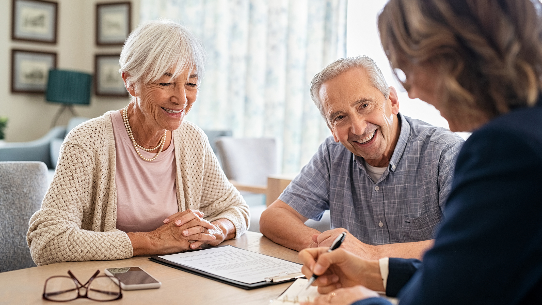 Senior couple consulting with agent.