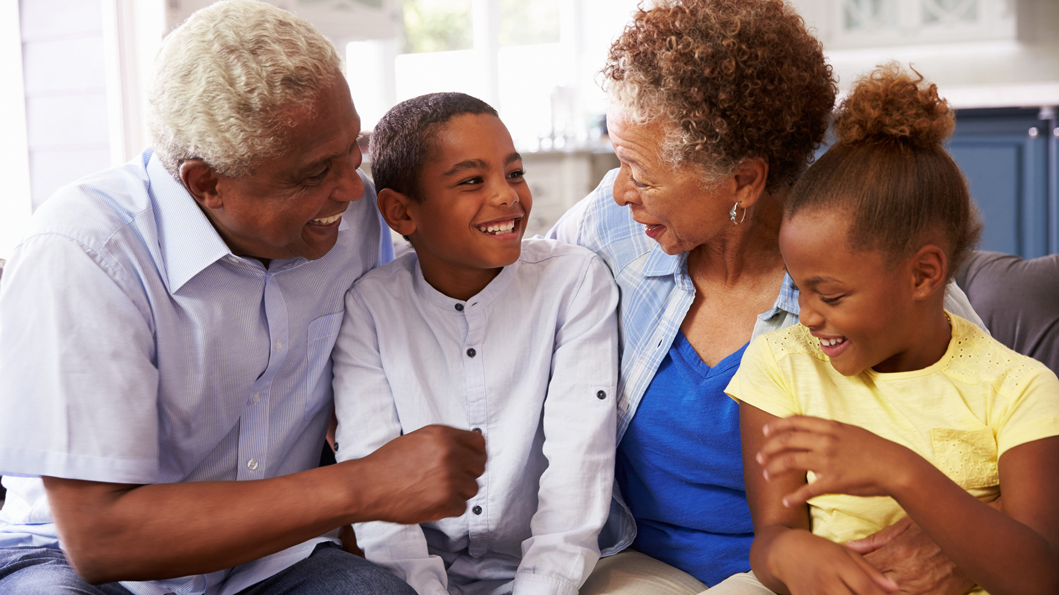 Senior couple and children smiling at each other. 