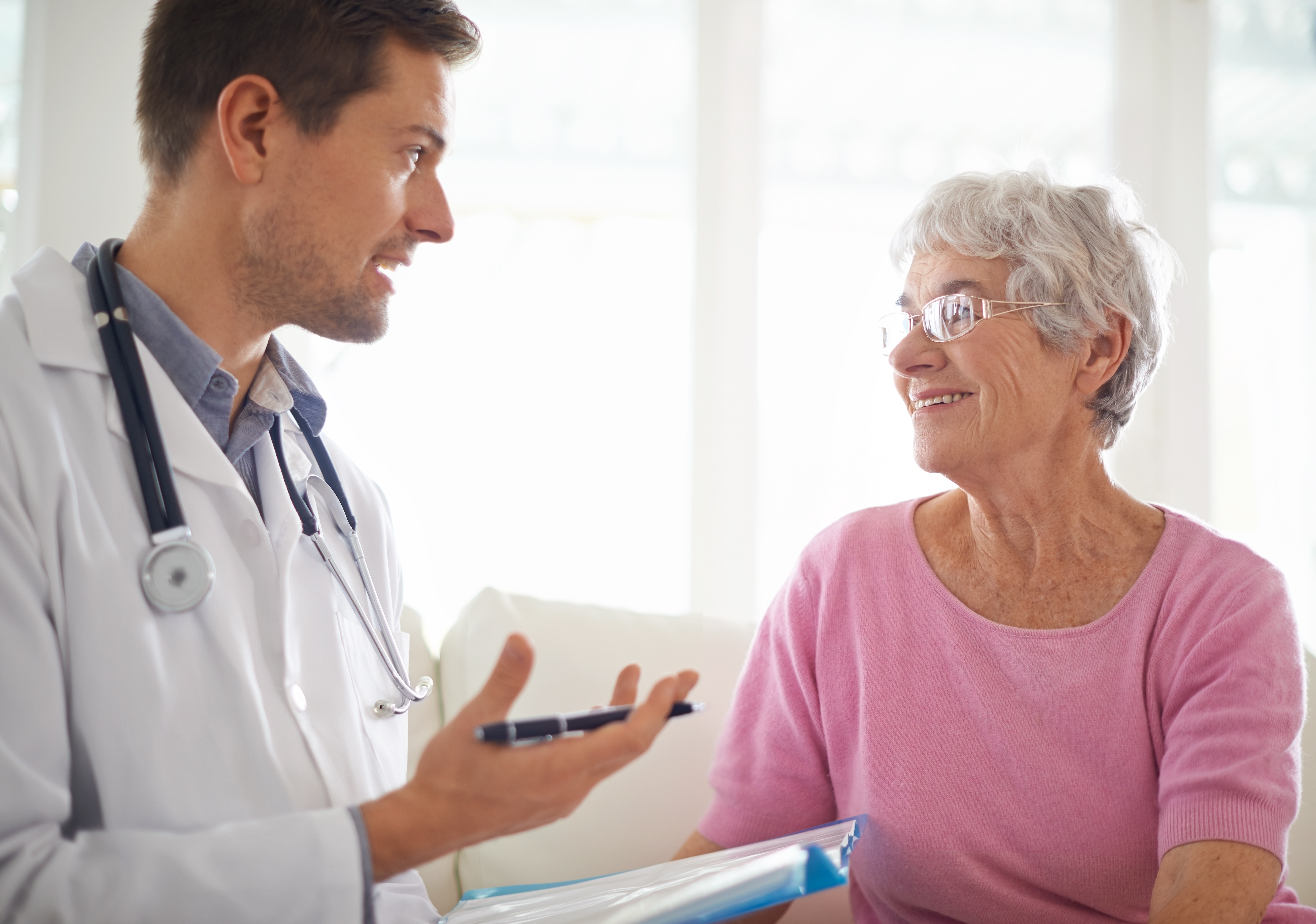 Senior woman speaking with male doctor