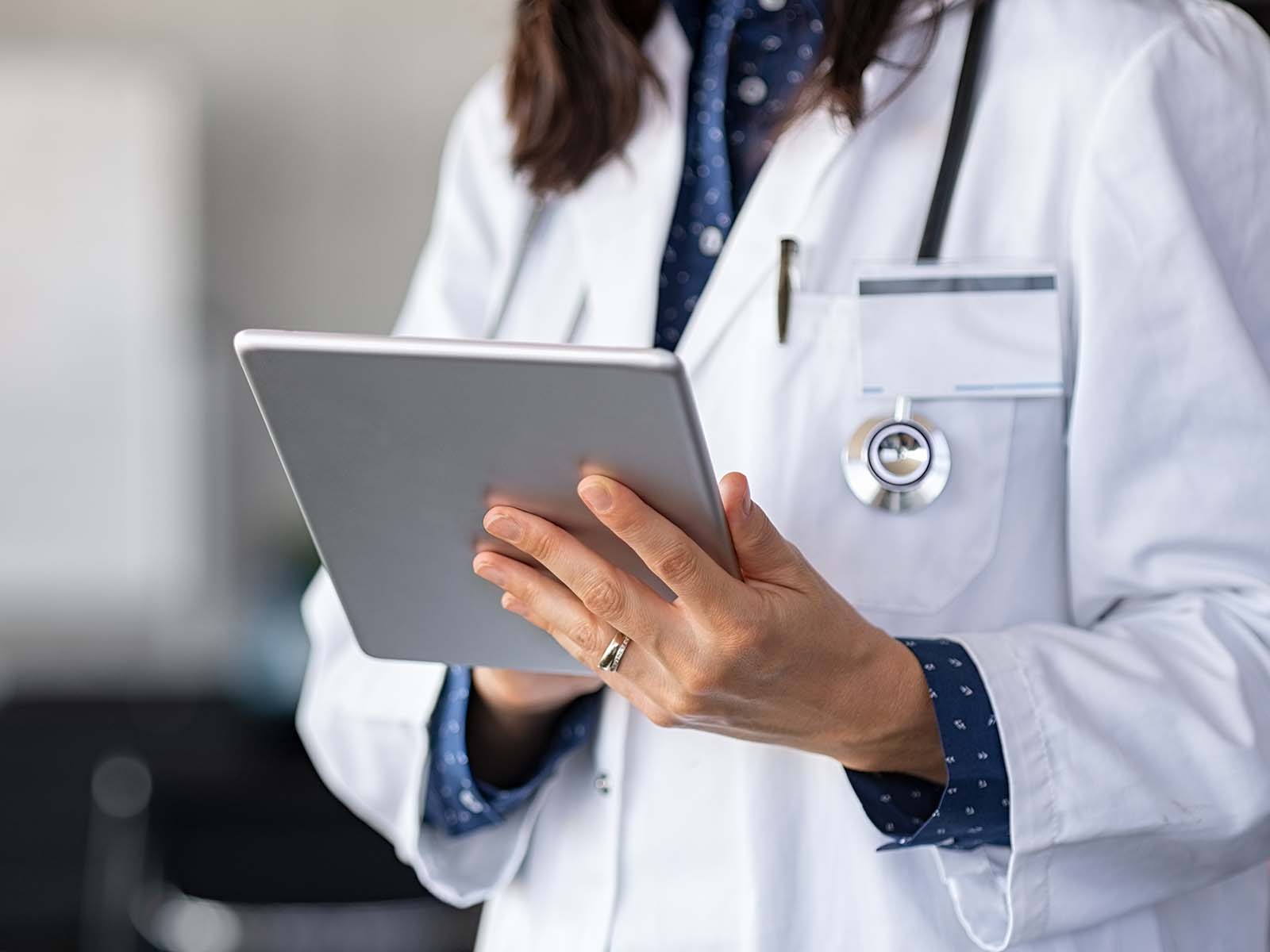 Healthcare professional using a tablet.