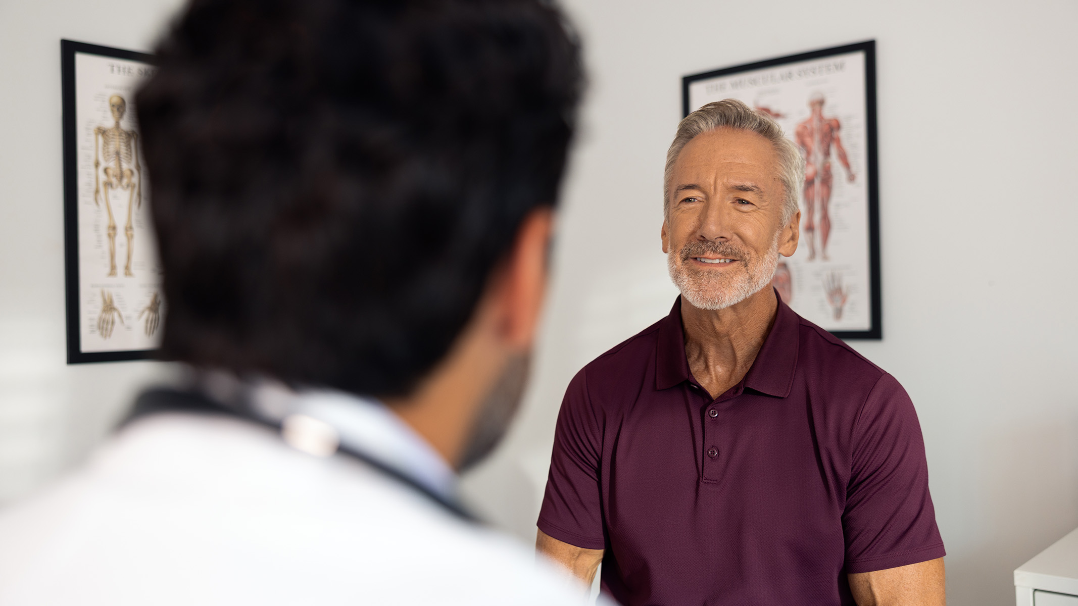 A healthcare provider consults with a patient in a medical office.
