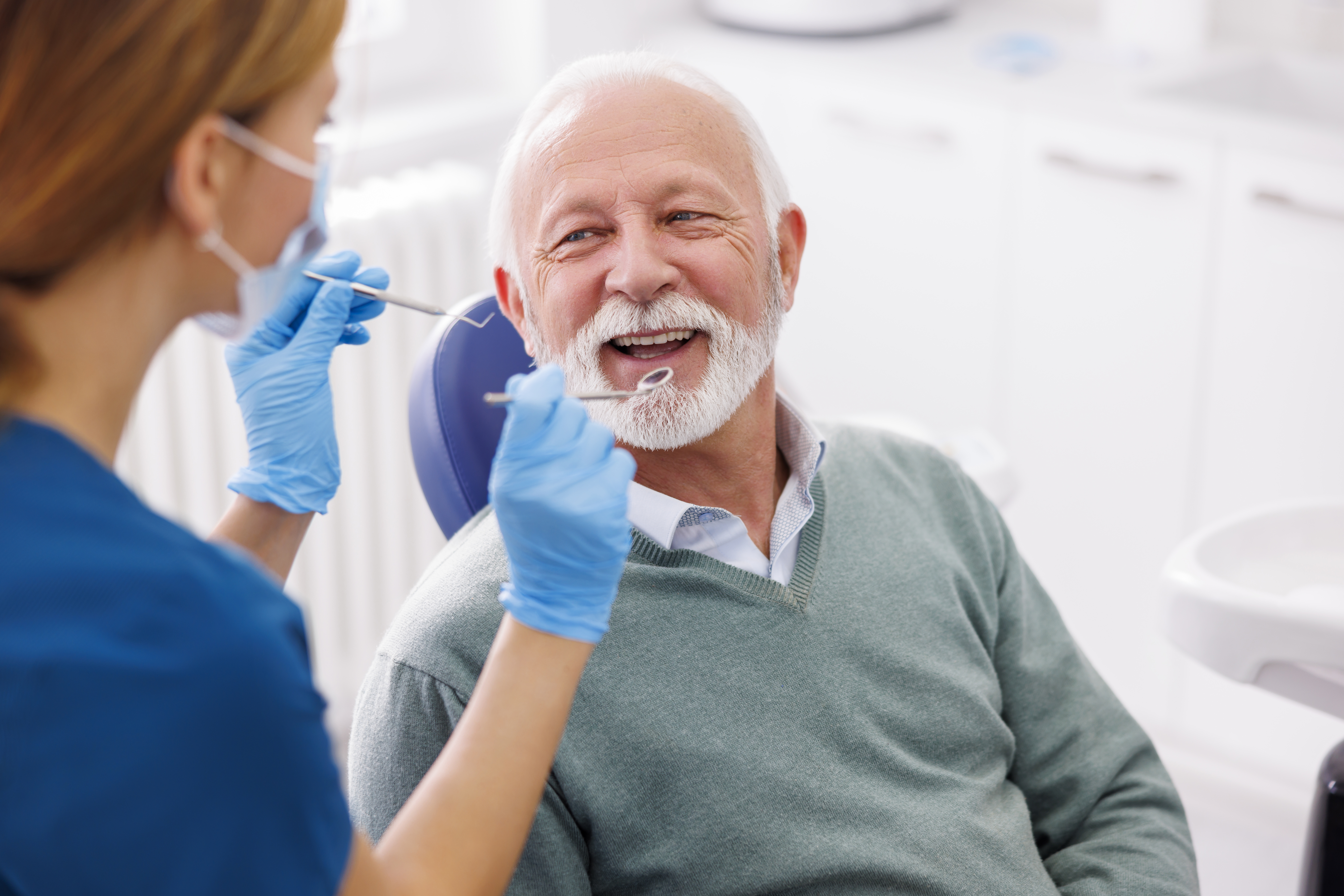  Senior man receiving dental care.