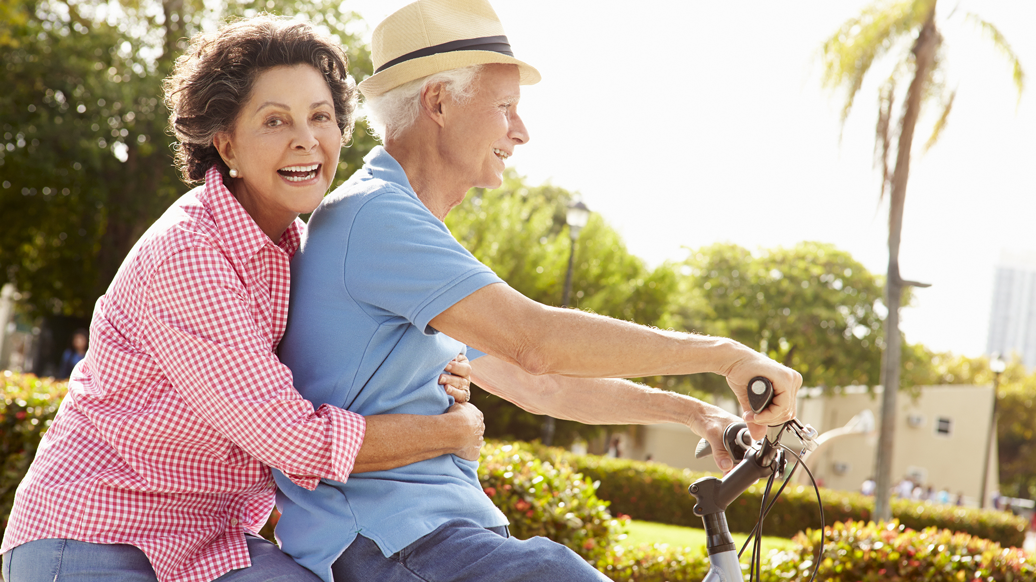 Senior couple riding a bicycle.
