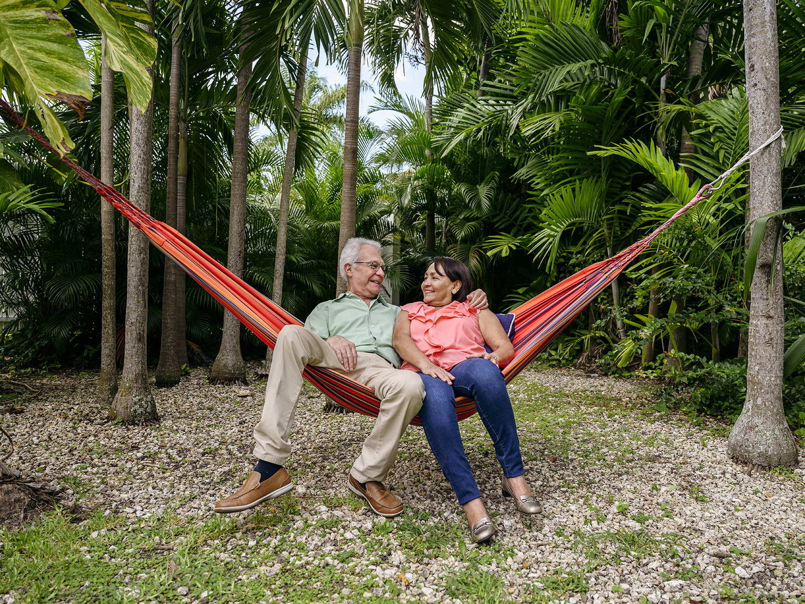Senior couple relaxing on hammock in backyard