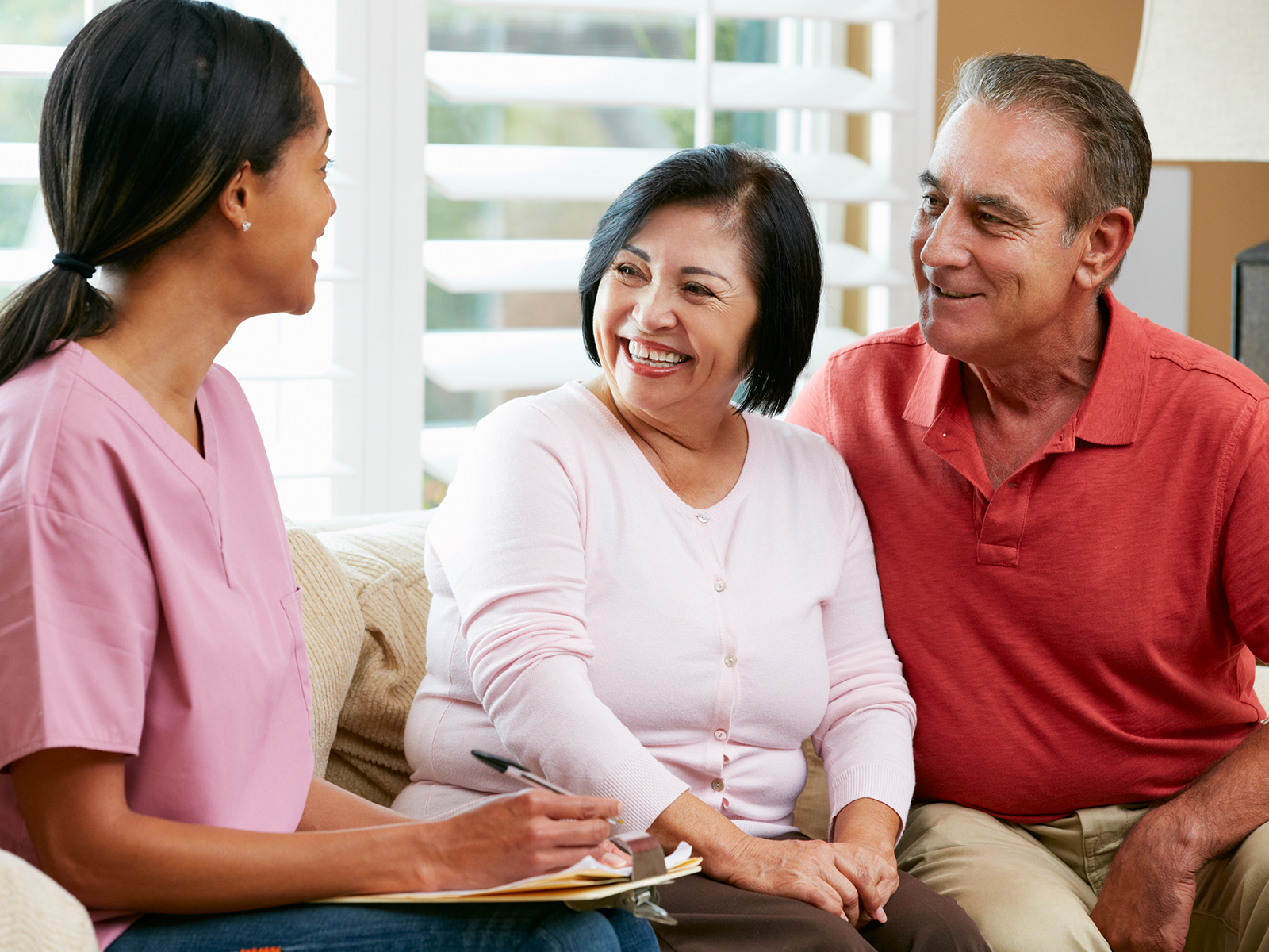 Senior couple talking to financial professional.