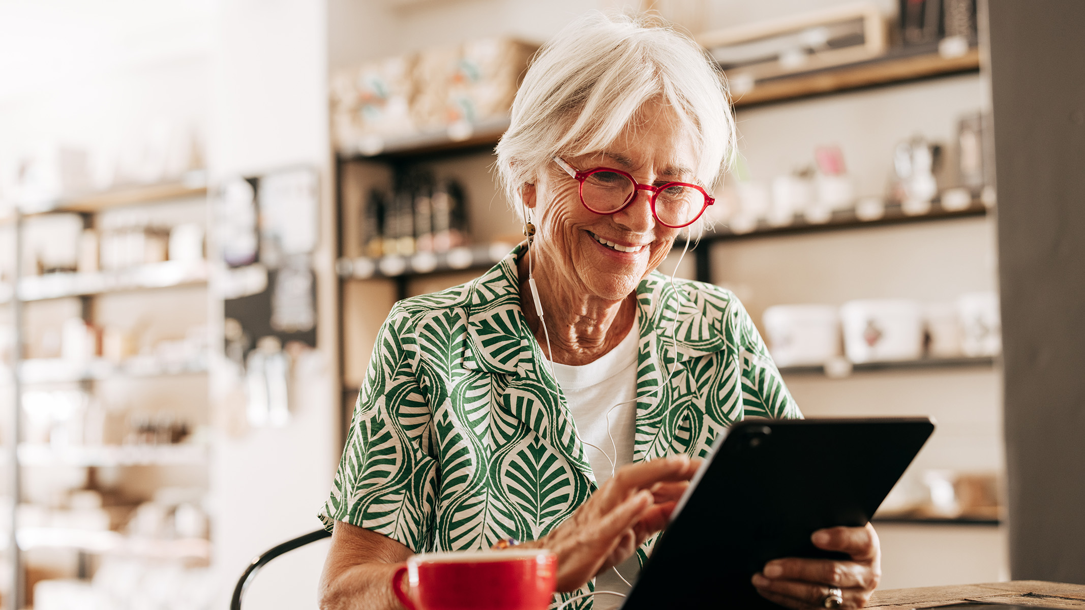 Senior woman reading on a tablet.