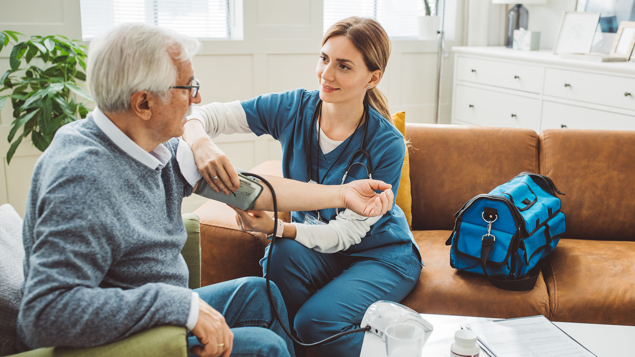 Senior with healthcare worker at home.